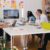 Start-up - five person by table watching turned on white iMac