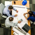 Project Management Resources - Three People Sitting Beside Table