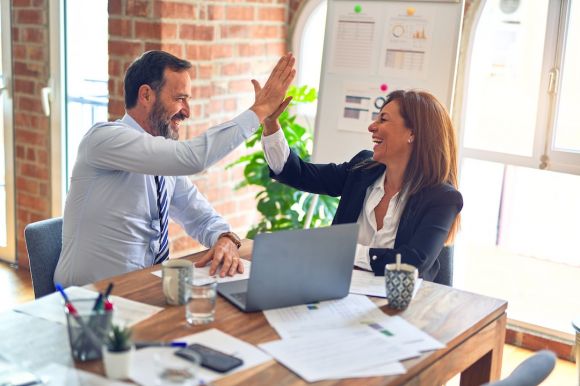 Start-up Success - man in white dress shirt sitting beside woman in black long sleeve shirt