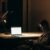 Stay Competitive - Man in Black and White Stripe Dress Shirt Sitting on Chair in Front of Macbook